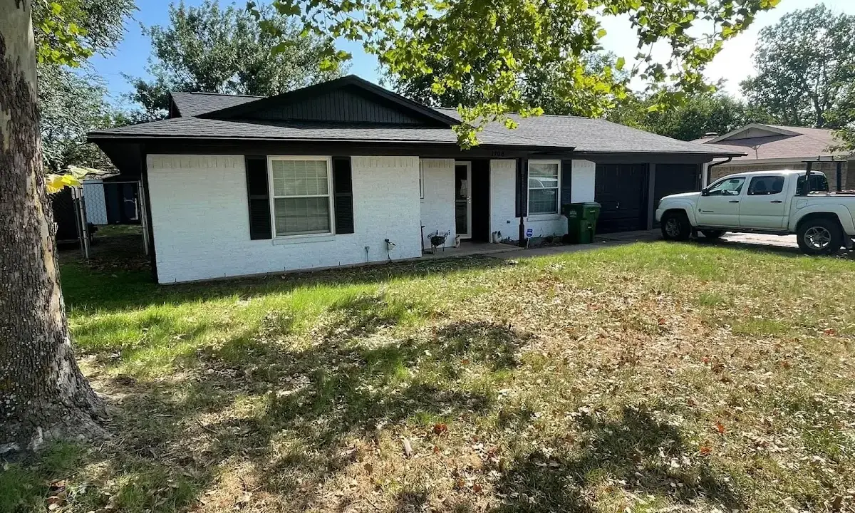 Professional roofing crew working on a residential roof in Cumberland